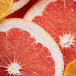 Detailed image of grapefruit and orange slices showcasing their fresh and vibrant colors.